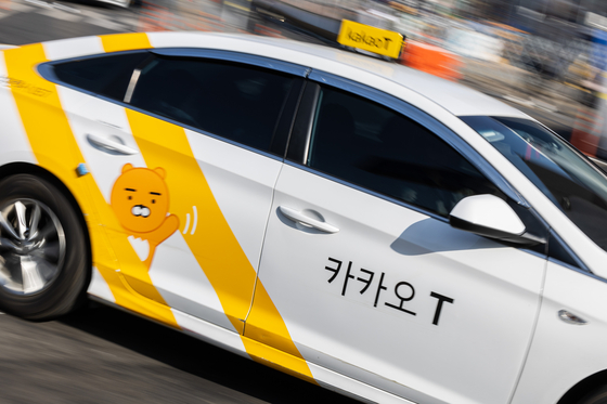 A Kakao T Blue taxi drives through a street in Jung District, central Seoul in February, 2023. [YONHAP]