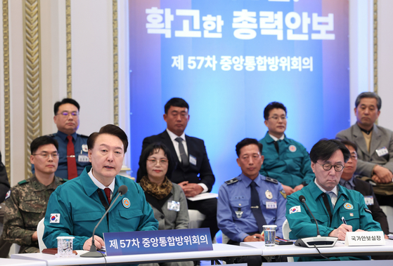 President Yoon Suk Yeol, front left, presides over the 57th central integrated defense council meeting at the Blue House in central Seoul on Tuesday, attended by some 170 officials and civilians. [JOINT PRESS CORPS]