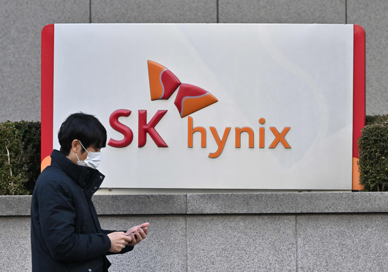 A man walks past the logo of SK Hynix outside the company's Bundang office in Seongnam on January 26, 2024. [AFP]