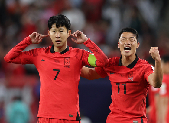 Son Heung-min, left, celebrates with Hwang Hee-chan after scoring during a quarterfinal match between Korea and Australia at the Asian Cup in Doha, Qatar on Feb. 2.  [XINHUA/YONHAP]