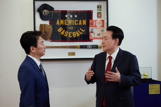 President Yoon Suk Yeol, right, shows a KBS anchor gifts he received from U.S. President Joe Biden in his state visit to Washington last year during a tour of the Yongsan presidential office in Seoul on Sunday for an interview with the public broadcaster. The interview was aired on Wednesday evening, ahead of the Lunar New Year holiday. [PRESIDENTIAL OFFICE]