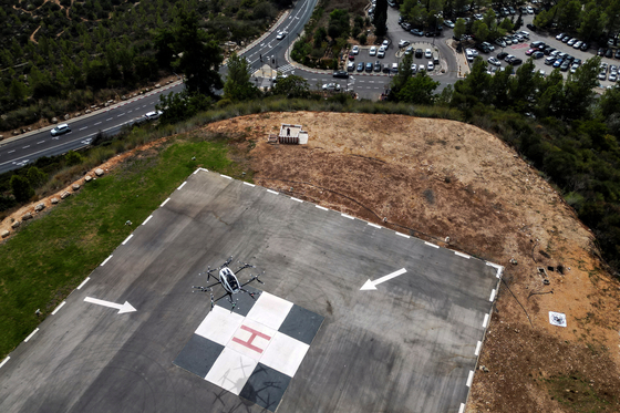 An aerial view shows an EHang air taxi, an autonomous electric vertical takeoff and landing aircraft flying near a helicopter pad at Hadassah Ein Kerem Hospital, in Jerusalem on Sept. 12, 2023. [REUTERS]