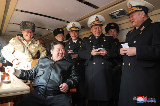 North Korea leader Kim Jong-un, sitting, oversees the launch of a new surface-to-sea cruise missile on Wednesday in a photo carried by its official Korean Central News Agency (KCNA) Thursday. [YONHAP]
