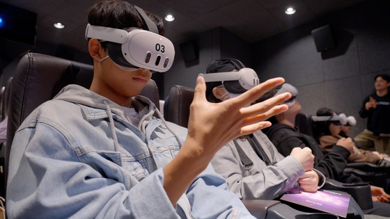 Audiences experience aespa's first virtual reality (VR) concert ″Lynk-pop: The 1st VR concert aespa″ at Megabox's COEX branch in southern Seoul [AMAZE VR]