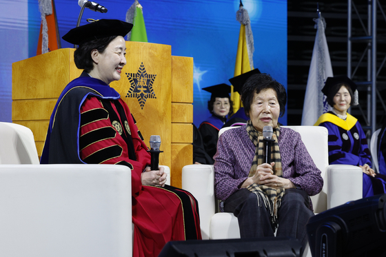 Kim Jeong-ja, right, 83, the oldest person to take the 2024 College Scholastic Ability Test (CSAT), speaks on Monday at the entrance ceremony for Sookmyung Women's University in central Seoul, seated next to Chang Yun-keum, the school’s president. Kim will become a freshman majoring in social welfare at the university’s Future Education Institute. Born in 1941, Kim had to flee when the 1950-53 Korean War broke out around the time she entered elementary school. [NEWS1]