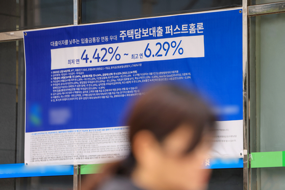 Korea’s household credit stood at a record 1,886.4 trillion won ($1.41 trillion) at the end of December, up 8 trillion won or 0.4 percent from the previous quarter, according to preliminary data by the Bank of Korea released on Tuesday. A banner promotes mortgage products in front of a bank in Seoul. [YONHAP]