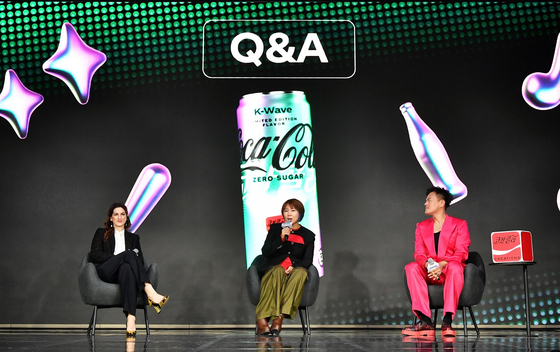 From left, Oana Vlad, senior director of global brand strategy at Coca-Cola; Kwon Jung-hyun, TM category lead at Coca-Cola; and Park Jin-young, chief producer of JYP Entertainment, answer questions from press during a global media conference in Yeuido, western Seoul, on Tuesday. [COCA-COLA COMPANY]