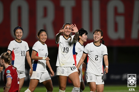 Korea's Casey Phair, center, celebrates with her teammates during a friendly with the Czech Republic at City of Football in Portugal on Saturday. [KOREA FOOTBALL ASSOCIATION]
