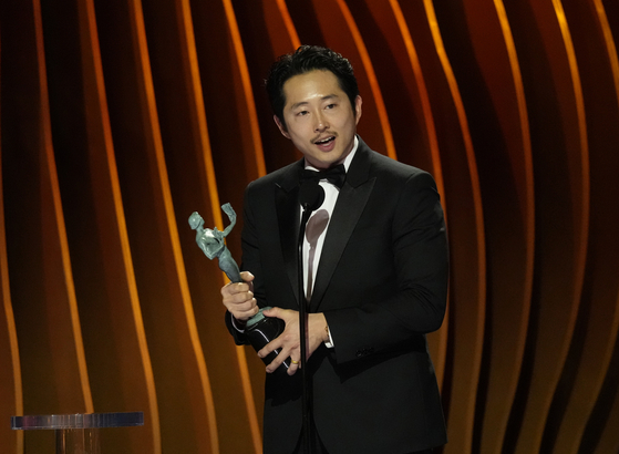 Actor Steven Yeun accepts the award for outstanding performance by a male actor in a television movie or limited series for ″Beef″ during the 30th annual Screen Actors Guild Awards on Saturday at the Shrine Auditorium in Los Angeles. [AP/YONHAP]