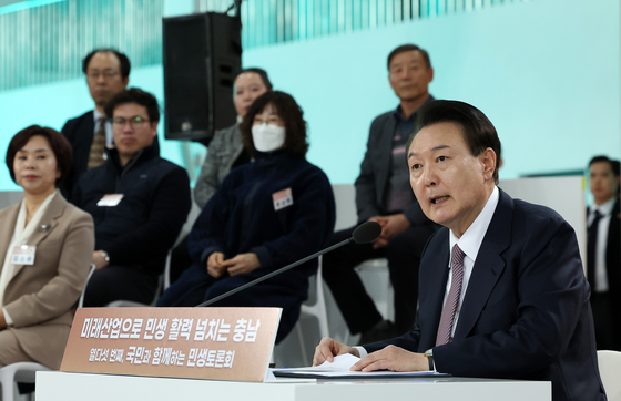 President Yoon Suk Yeol, right, speaks at the 15th public livelihood debate at Seosan Air Base in South Chungcheong, on Monday. [JOINT PRESS CORPS]