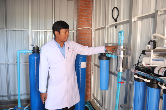 A local official checks an installed water filtration system in Cambodia, in November 2023. [FILA]