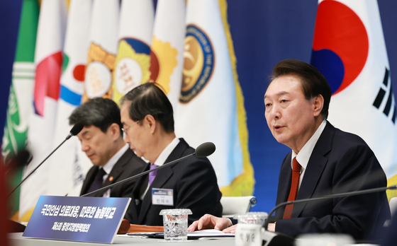 President Yoon Suk Yeol, right, speaks at a conference on regional cooperation at the Blue House in central Seoul on Tuesday. [YONHAP]