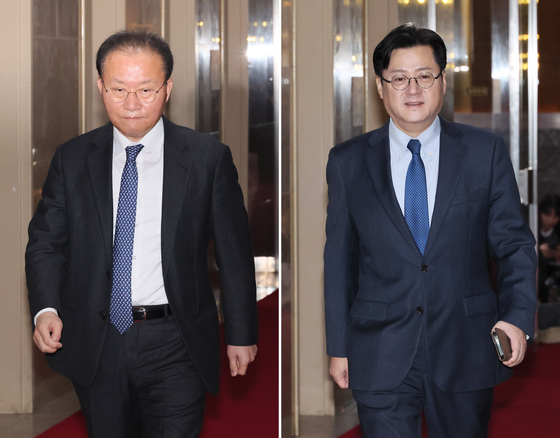 Rep. Yun Jae-ok, floor leader of the conservative People Power Party (PPP), left, and his liberal Democratic Party (DP) counterpart Rep. Hong Ihk-pyo, right, walk toward the speaker's office at the National Assembly in Yeouido, western Seoul, before their meeting on Thursday. [YONHAP]