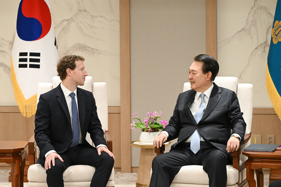 President Yoon Suk Yeol, right, chats with Mark Zuckerberg, the chief executive of Meta, at the Yongsan presidential office in central Seoul on Wednesday. [PRESIDENTIAL OFFICE]
