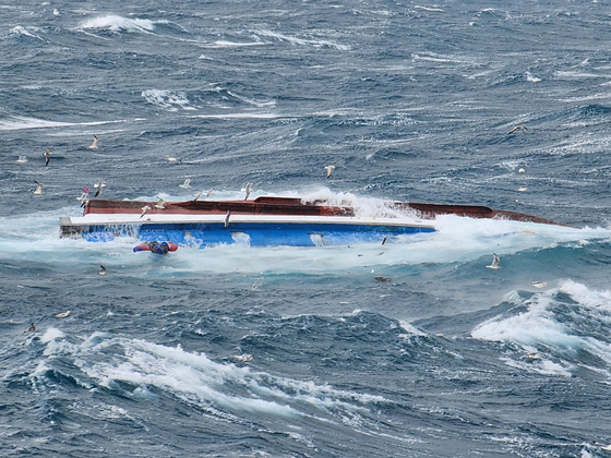 A fishing boat is seen capsized in waters off the southern island of Jeju on March 1, 2024. [YONHAP]