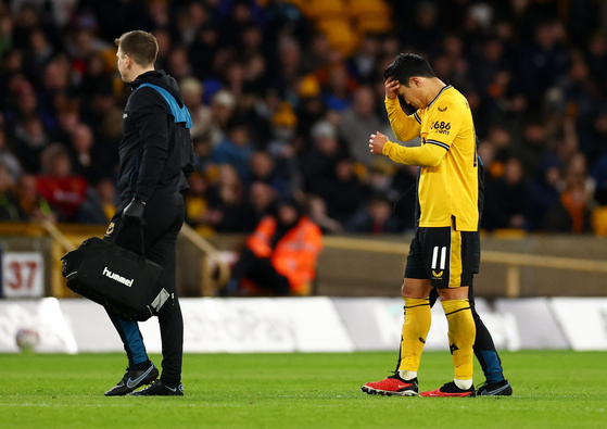 Wolverhampton Wanderers' Hwang Hee-chan is substituted after sustaining an injury during an FA Cup fifth round game against Brighton at the Molineux in Wolverhampton on Wednesday.  [REUTERS/YONHAP]