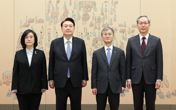 President Yoon Suk Yeol, center left, takes a commemorative photo after presenting letters of appointment to two new Supreme Court justice at the presidential office in Yongsan, central Seoul, on Tuesday, alongside Chief Justice Cho Hee-dae, center right. Yoon recently named veteran judges, Shin Sook-hee, left, and Eom Sang-phil, right, to seats at the court. [JOINT PRESS CORPS]