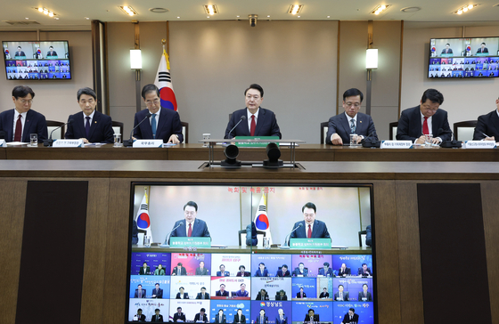 President Yoon Suk Yeol, center, speaks during an interagency meeting on the Neulbom School child care program at the Sejong government complex on Wednesday. [JOINT PRESS CORPS]