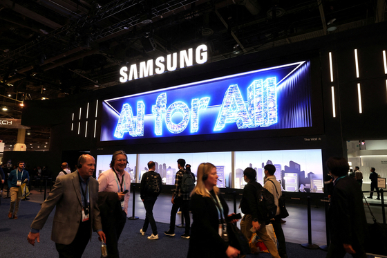 FILE PHOTO: People walk past a Samsung Electronics booth during CES 2024, an annual consumer electronics trade show, in Las Vegas, Nevada, U.S. January 9, 2024. REUTERS/Steve Marcus/File Photo
