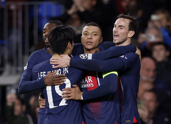 Paris St Germain's Kylian Mbappe celebrates scoring their second goal with Lee Kang-in, Ousmane Dembele and Fabian Ruiz at the Anoeta Stadium in San Sebastian, Spain on Tuesday.   [REUTERS/YONHAP]