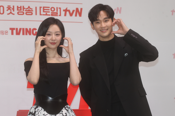 Actors Kim Soo-hyun, right, and Kim Ji-won take a picture during a press conference for "Queen of Tears" on Thursday. [YONHAP] 