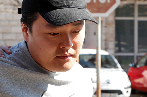 Do Kwon, the cryptocurrency entrepreneur, who created the failed TerraUSD stablecoin, is taken to court in handcuffs, to face charges of forging official documents, in Podgorica, Montenegro, March 24, 2023. [REUTERS/YONHAP]