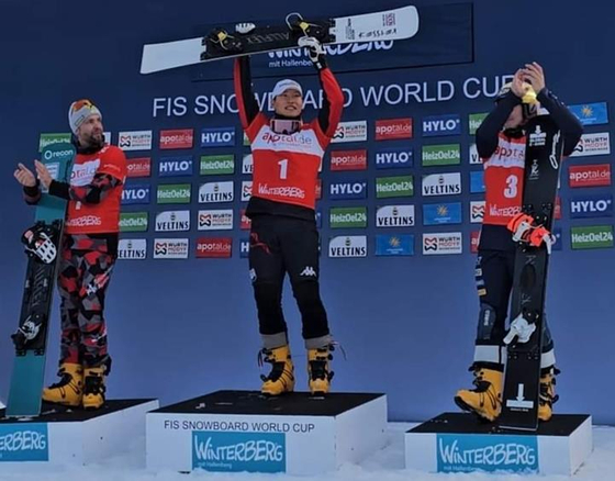 Snowboarder Lee Sang-ho, center, celebrates after winning a gold medal in the 2023-24 International Ski Federation World Cup parallel slalom in Germany on Saturday. With the gold, Lee topped the parallel slalom discipline with 313 points in total, becoming the overall winner in the discipline. He came to prominence at the 2018 PyeongChang Olympics where he claimed a silver medal. [YONHAP] 