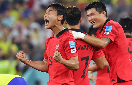 Korea's Paik Seung-ho, left, celebrates scoring during a 2022 Qatar World Cup round of 16 match against Brazil at Stadium 974 in Doha, Qatar on Dec. 6, 2022. [YONHAP] 