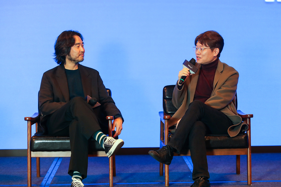 Lee Kwon, co-director of the streaming platform’s action series “A Shop for Killers,” left, and Shin Yeon-shick, director of Disney+’s upcoming series “Uncle Samsik,” speak to the press at JW Marriott Hotel Dongdaemun Square in central Seoul on Tuesday. [WALT DISNEY COMPANY KOREA]