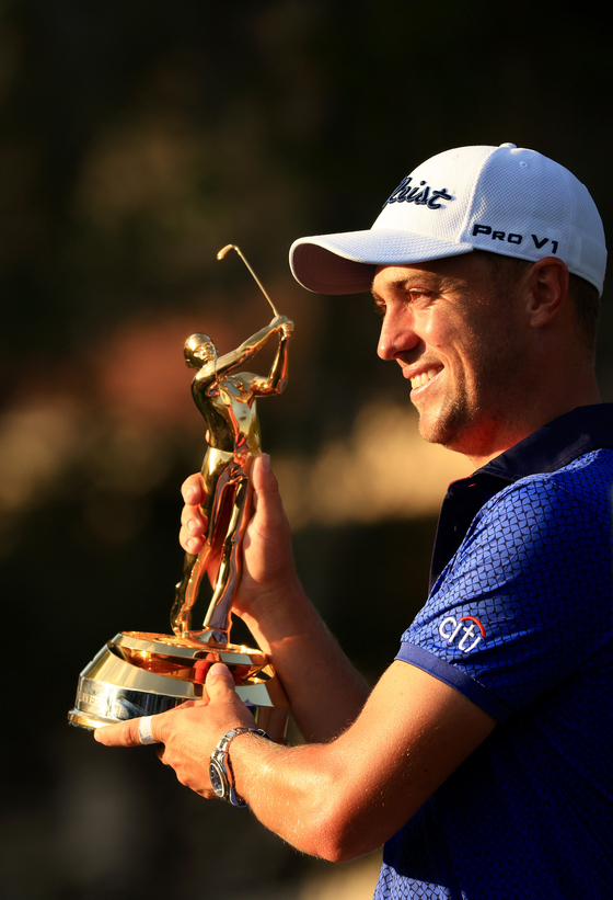 Justin Thomas of the United States celebrates with the trophy after winning The Players Championship at TPC Sawgrass on March 14, 2021 in Ponte Vedra Beach, Florida. [GETTY IMAGES]