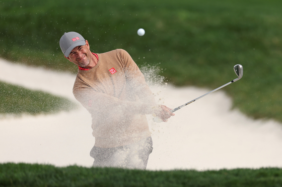 Adam Scott of Australia plays a shot from a bunker ahead of the AT&T Pebble Beach Pro-Am at Pebble Beach Golf Links in Pebble Beach, California in January. [GETTY IMAGES]
