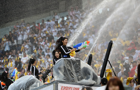 LG Twins cheerleaders fire water pistols at the crowd during a game against the Kiwoom Heroes at Jamsil Baseball Stadium in southern Seoul on Aug. 11, 2023.  [NEWS1]