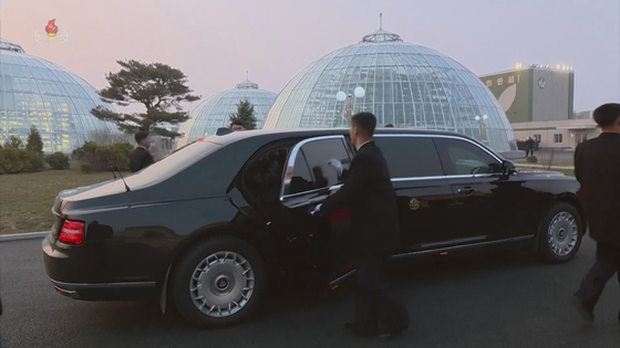 North Korean leader Kim Jong-un makes a public appearance for the first time riding in an Aurus Senat limousine gifted by Russian President Vladimir Putin to attend a ceremony marking the completion of building a greenhouse farm near Pyongyang on Friday, as seen in a video footage released by the state-run Korean Central Television Saturday. [YONHAP]