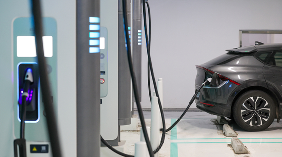 An EV is being charged at a charging station in Seoul on March 14. [YONHAP]