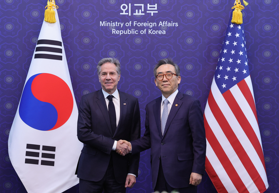 Foreign Minister Cho Tae-yul, right, shakes hands with U.S. Secretary of State Antony Blinken during a meeting on the sidelines of the third Summit for Democracy at the Ministry of Foreign Affairs office in Jongno District, central Seoul, on Monday. [YONHAP] 