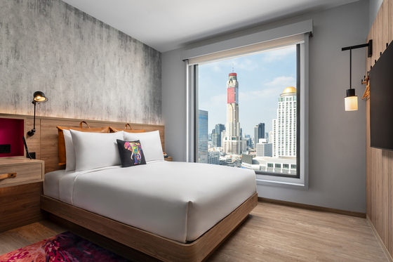 With over 30 brands, Marriott's hotels range from mid-range to luxury, long-stays and home rentals. Shown in the photo is a room in Moxy Bangkok, Thailand. [MARRIOTT INTERNATIONAL]