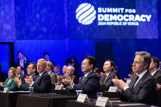 President Yoon Suk Yeol, center, attends the opening ceremony of the third Summit for Democracy held at The Shilla Seoul in Jung District, central Seoul, on Monday. [PRESIDENTIAL OFFICE] 