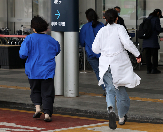 Medical professionals run into a hospital in Seoul on Tuesday. [NEWS1] 