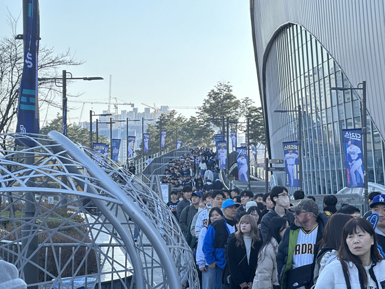 The line for the MLB Superstore extends out of the roped off waiting area and around the perimeter of Gocheok Sky Dome in western Seoul.  [JIM BULLEY]