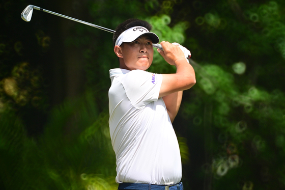 Carl Yuan plays his shot from the third tee during the final round of the Valspar Championship at Copperhead Course at Innisbrook Resort and Golf Club in Palm Harbor, Florida on Sunday. [GETTY IMAGES]