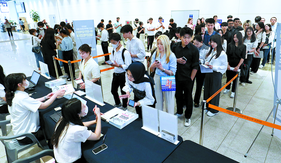 Visitors line up at a job fair for international students at the Busan Port International Exhibition and Convention Center on July 20, 2023. The fair was attended by some 300 participants, including organizations based in Busan interested in hiring foreign students and residents. [SONG BONG-GEUN]