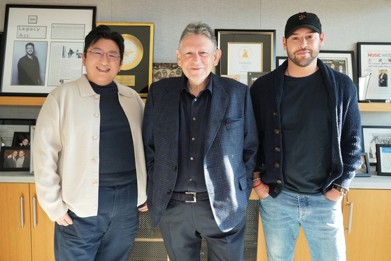 From left, HYBE Founder and Chair Bang Si-hyuk, Universal Music Group (UMG) Chair and CEO Lucian Grainge and HYBE America CEO Scooter Braun pose for a photo. HYBE and UMG closed a deal that will give UMG exclusive digital and physical distribution rights to HYBE artists' music for the next 10 years. [HYBE]