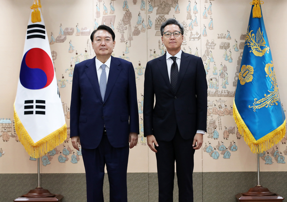 President Yoon Suk Yeol, left, presents credentials to Korean Ambassador to China Chung Jae-ho at the Yongsan presidential office in central Seoul on July 15, 2022. [JOINT PRESS CORPS]