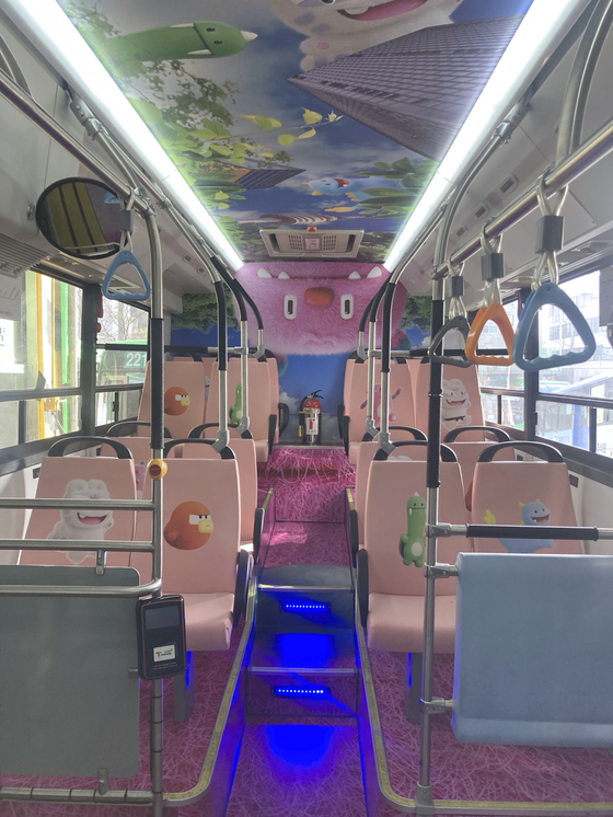 The interior of a bus, including bus seats, is decorated with designs featuring Hechi and Soul Friends. [SEOUL METROPOLITAN GOVERNMENT]