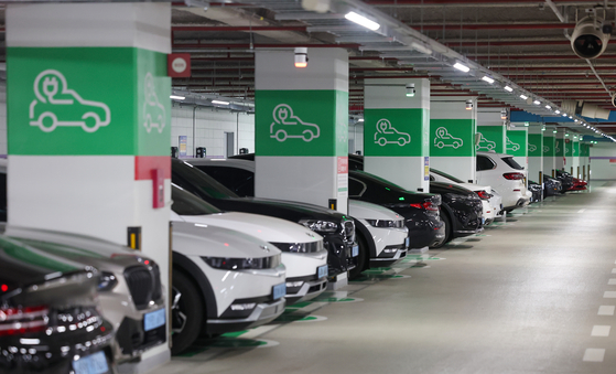 This photo taken on Feb. 20, 2024, shows EVs parked at charging stations at a parking lot in Seoul. [YONHAP]