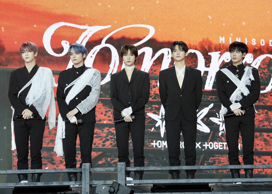 Members of boy band Tomorrow X Together pose for photos during a showcase held on Monday at the Hwajeong Gymnasium in Korea University, central Seoul, for the release of the band's sixth EP ″minisode 3: Tomorrow.″ [CELEB CONFIRMED]
