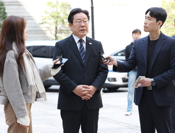 Democratic Party (DP) leader Lee Jae-myung speaks to the press as he attends a trial at Seoul Central District Court in Seocho District, southern Seoul, on Tuesday. Tuesday marked the DP chief's second trial during the campaign period for the April 10 general election. [YONHAP] 