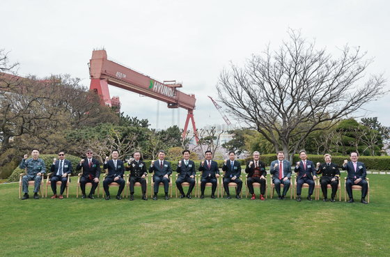 HD Hyundai Heavy Industries officials take a commemorative photo after the delivery signing ceremony of Shin Chae-ho at its Ulsan shipyard with guests from the Ministry of National Defense, the Defense Acquisition Program Administration and government officials from nine countries on Thursday. [HD HYUNDAI HEAVY INDUSTRIES]