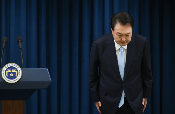 President Yoon Suk Yeol bows after finishing his public address on medical reform at the presidential office in Yongsan, central Seoul on Monday, a day before inviting junior doctors to join a direct dialogue with him. [PRESIDENTIAL OFFICE]