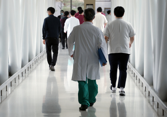 Medical profesionals walk inside a general hospital in Seoul on Wednesday, 44 days after junior doctors filed their resignations en masse and staged a walkout. [NEWS1] 